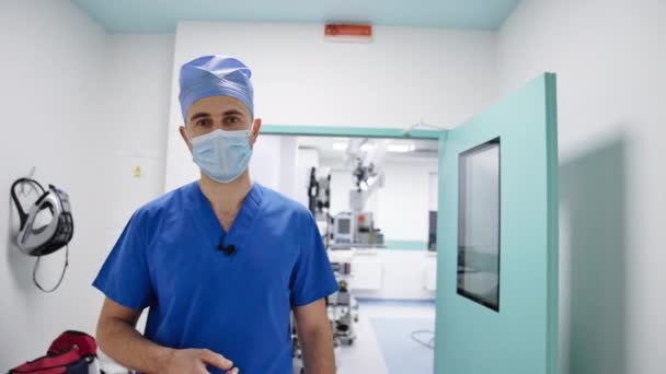 Profissional Saúde Fica Frente Sala Cirúrgica Fala Doutor Uniforme Máscara — Vídeo de Stock