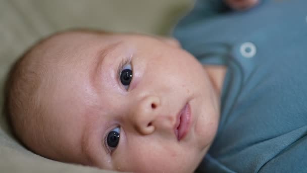 Härligt Söt Baby Tittar Uppmärksamt Kameran Ett Gulligt Litet Barn — Stockvideo