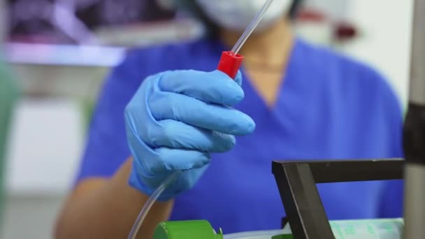 外科医生助手的手安装注射器滴注 在操作过程中控制医疗设备 模糊的背景 — 图库视频影像