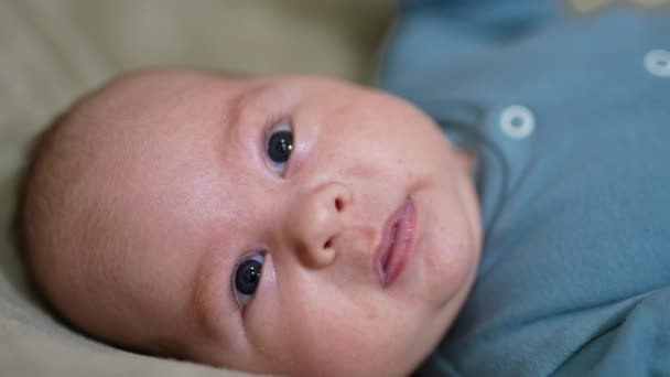 Bedårande Babyansikte Porträtt Tittar Kameran Söta Barn Ligger Rygg Fortfarande — Stockvideo