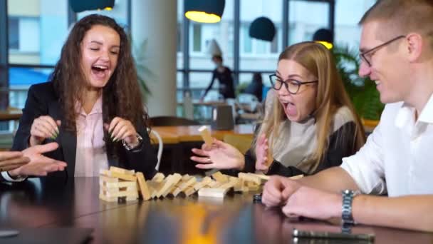 Friends Colleagues Having Fun Playing Jenga Blonde Girl Pulls Brick — Stock Video