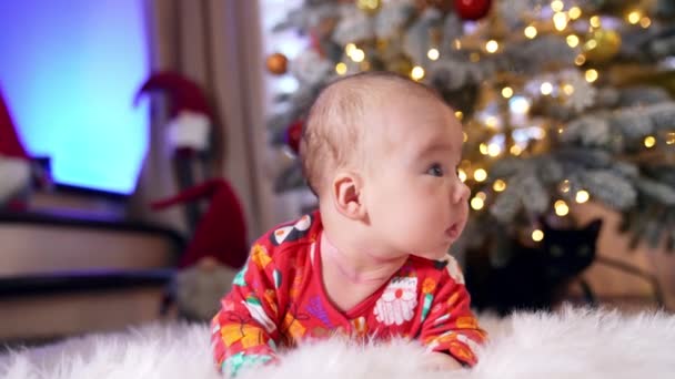 Infant Baby Red Costume Lies His Belly Front New Year — Stock Video
