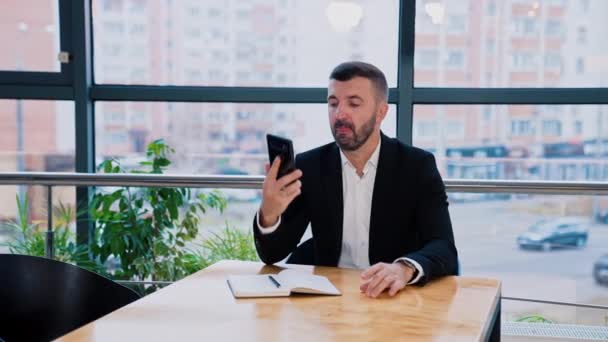 Male Businessman Sitting Table Going Make Call Man Takes Paper — Stock Video