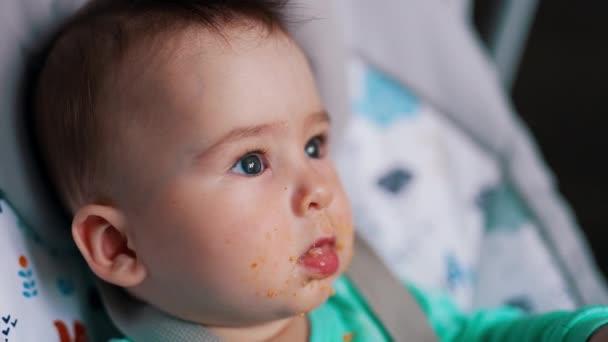 Caucasian Baby Dirtied Food Feeding Little Kid Shoves Spoon Mouth — Stock Video