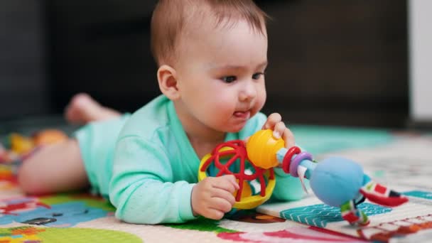 Lovely Baby Boy Playing Two Toys Tiny Child Lies Mat — Stock Video