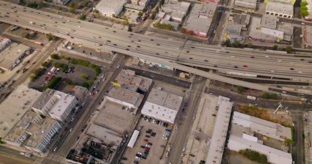 晴れた日のロサンゼルスの道路の交通 アメリカ合衆国のメトロポリスの低い建物の上のドローン映像 トップビュー — ストック動画