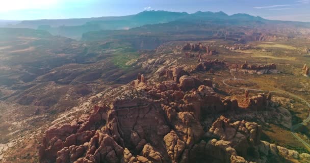 アメリカ合衆国ユタ州の岩層の素晴らしい景色の上に登る 青い空の下に美しい渓谷の晴れたパノラマ トップビュー — ストック動画
