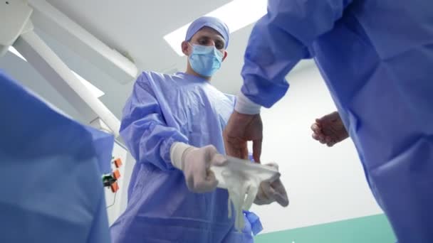 Erkek Asistan Cerrahın Lateks Eldiven Giymesine Yardım Ediyor Cerrahi Operasyon — Stok video
