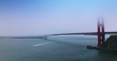 Beyaz yat Golden Gate 'i geçiyor San Francisco, California, ABD' de. Kalın siste saklanan adaş köprüsünün kısmi görüntüsü.
