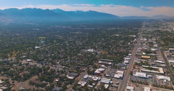高山によって制限された緑豊かな都市の素晴らしい景色 空中からの晴れた日のソルトレイクシティのパノラマ — ストック動画