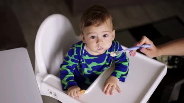 Een Klein Kind Aan Een Witte Eettafel Wordt Gevoed Door — Stockvideo