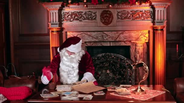 Santa Finishes Writing Christmas Cards Red Feather Santa Claus Stands — Stock Video