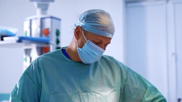 Уверенный Хирург Мужчина Маске Периодически Смотрит Камеру Комментирует Врач Выполняющий — стоковое видео