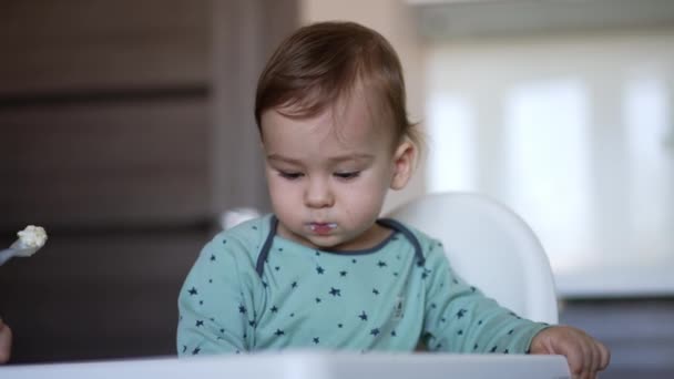 One Year Old Baby Boy Sitting Feeding Chair Eating Spoon — Stock Video