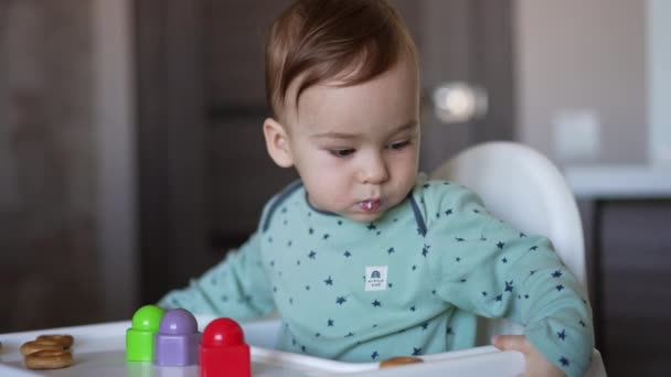 Cute Little Toddler Sitting Feeding Chair Holding Some Food His — Stock Video