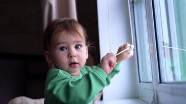 Smart Little Kid Playing Rope Jalousie Standing Window Sill Cute — Stock Video