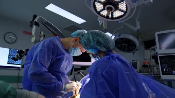 現代の手術室で操作するデバイスツールを使用して慎重な医師 設備の整ったオペレーショナルシアターでメディック — ストック動画