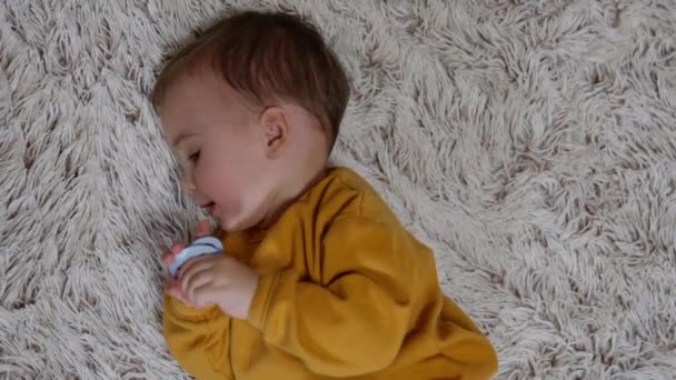 Sweet Kid Rolls Soft Fluffy Carpet Little Boy Orange Sport — Stock Video