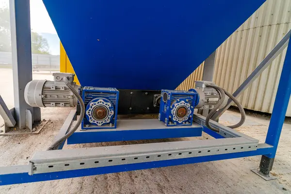 Blue industrial mixer is used for mixing concrete.