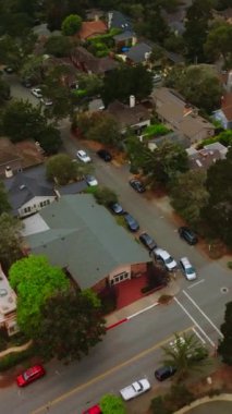 Karmel 'in deniz kenarında bir sürü yeşil ağacı olan bir yerleşim yeri. Güzel evleri olan güzel bir şehir manzarası. Havadan bakış açısı. Dikey video.