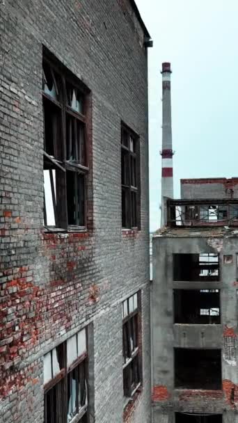 古いレンガとコンクリートの建物は 放棄された工場があります 都市の背景に建物を破壊した巨大な工業地帯 バーティカルビデオ — ストック動画