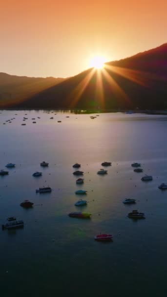 游艇和小船仍停在美国加州塔荷湖的水面上 深山轮廓以落日为背景 垂直录像 — 图库视频影像