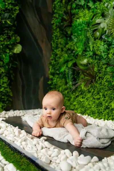 Маленька Дитина Лежить Ковдрі Зеленій Кімнаті Білими Каменями Зеленими Рослинами — стокове фото