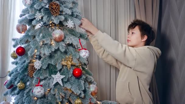 Bela Árvore Natal Alta Sendo Decorada Por Adolescente Garoto Branco — Vídeo de Stock