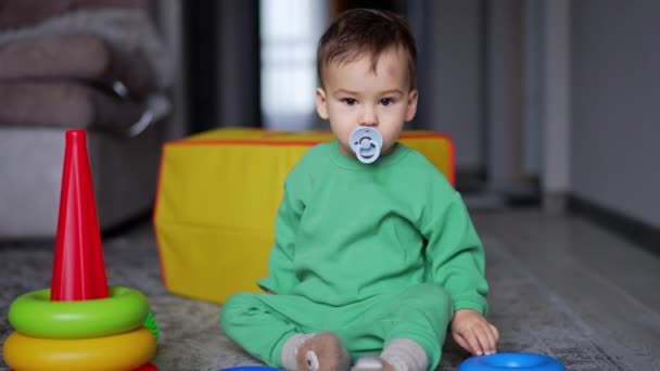 Sweet Little Toddler Pacifier Mouth Sits Floor Sleepy Baby Takes — Stock Video
