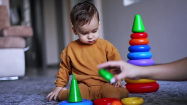 Calm Peaceful Kid Sitting Floor Watching His Mom Putting Toys — Stock Video