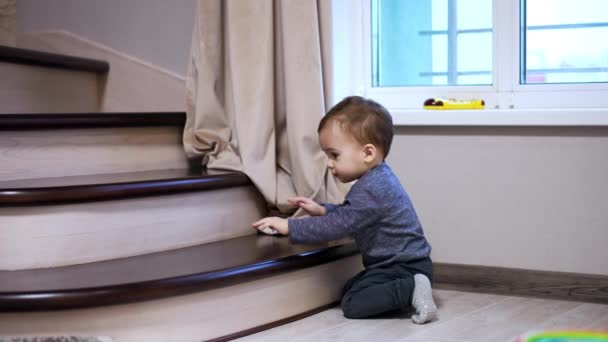 Smiling Little Toddler Climbs Stair Halts Moves Baby Playing Indoors — Stock Video