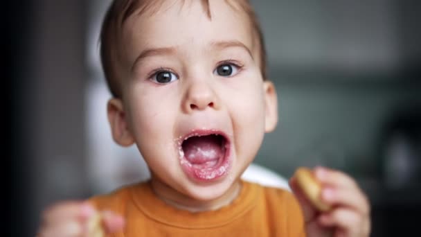 Cute Dark Haired Baby Smudged Face Opens Mouth Feeding Toddler — Stock Video