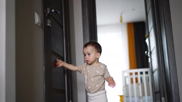 Adorable Baby Boy Stands Closed Door Toddler Waits Moment Switches — Stock Video