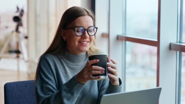 Uśmiechnięta Marzycielka Pije Kawę Patrząc Przez Okno Kobieta Przerwę Pracy — Wideo stockowe