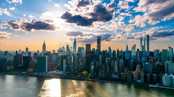 stock image Skyline of modern New York, the USA. Majestic skyscrapers on the waterfront under the cloudy sky at daytime.