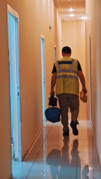 Back View Man Protective Suit Bag Going Corridor Male Worker — Stock Video