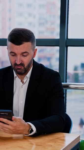 Calm Confident Bearded Man Holds Phone Sitting Desk Businessman Ready — стоковое видео