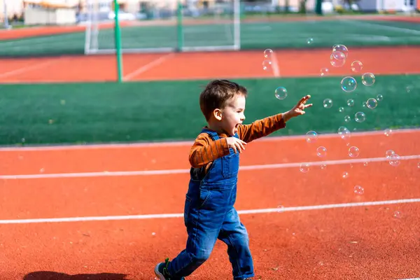 Young Boy Running Track Bubbles Air Scene Playful Fun Boy Imagine de stoc