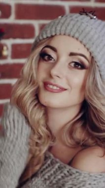 Noel odasında kadın portresi. Moda saçı ve makyajı olan genç ve güzel bir kadın Noel 'in içinde dikey görüntüler veriyor.