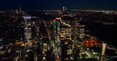 Geceleri New York 'un ışıltılı manzarası. Nehrin kara çizgisi panoramayı bölüyor. Üst görünüm.