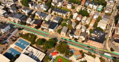 Cambridge, Massachusetts, ABD 'deki düşük katlı evlerin üstündeki uçuş. Parlak güneşli şehir manzarası, hava perspektifinden bol yeşillik..