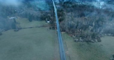 Sis dağılır ve yoldan iki araba geçerken manzarayı açar. Washington State, ABD 'deki Rainier Dağı Ulusal Parkı' nın manzarası. Üst görünüm.