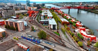 Portland, Oregon, ABD 'de iki tren karşılaşıp farklı taraflara gidiyor. Willamette Nehri 'nin rıhtımı. Suyun üstünde parlak kulübeleri ve Fremont ve Broadway Köprüleri manzarası var. Üst perspektif.