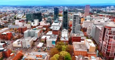 Portland, Oregon, ABD 'nin modern şehrinin devasa manzarası. Drone uçağı Willamette Nehri 'ne yaklaşıyor. Metropolis' i geçiyor..