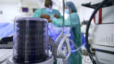 Akciğer havalandırma makinesi pompası hastaya hava üretiyor. Kapatın. Cerrahlar arkaplandaki işlemleri bulanıklaştırarak gerçekleştirir.