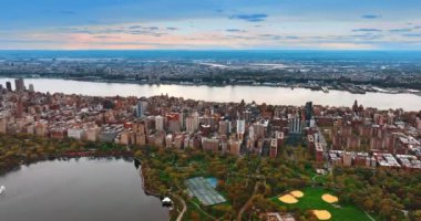 Panorama of the famous Central Park in New York. Drone footage above the vast city scenery at sunset.