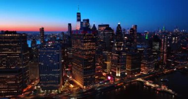 Manhattan, New York, ABD manzarasında pencereleri ışıklandırılmış güzel binalar. Arka planda ufukta pembe bir çizgi var. Üst görünüm.