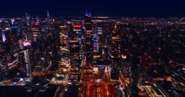 Geceleri New York 'un ışıl ışıl manzarası. İnsansız hava aracı, şehir merkezindeki canlı metropolün üzerinde sokaklarda bir sürü arabayla uçuyor..