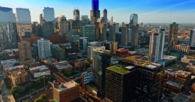 Flying over the cozy green zones located on the roof tops in the downtown of a modern city. Traffic jams on the highways of Chicago, Illinois, the USA.