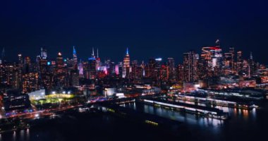 Canlı New York rıhtımlarına, ABD 'ye gece vakti yaklaşıyoruz. Doğu Nehri üzerinde İHA uçuşu. Gökdelenlerin tepeleri neon ışıklarıyla parlıyor..